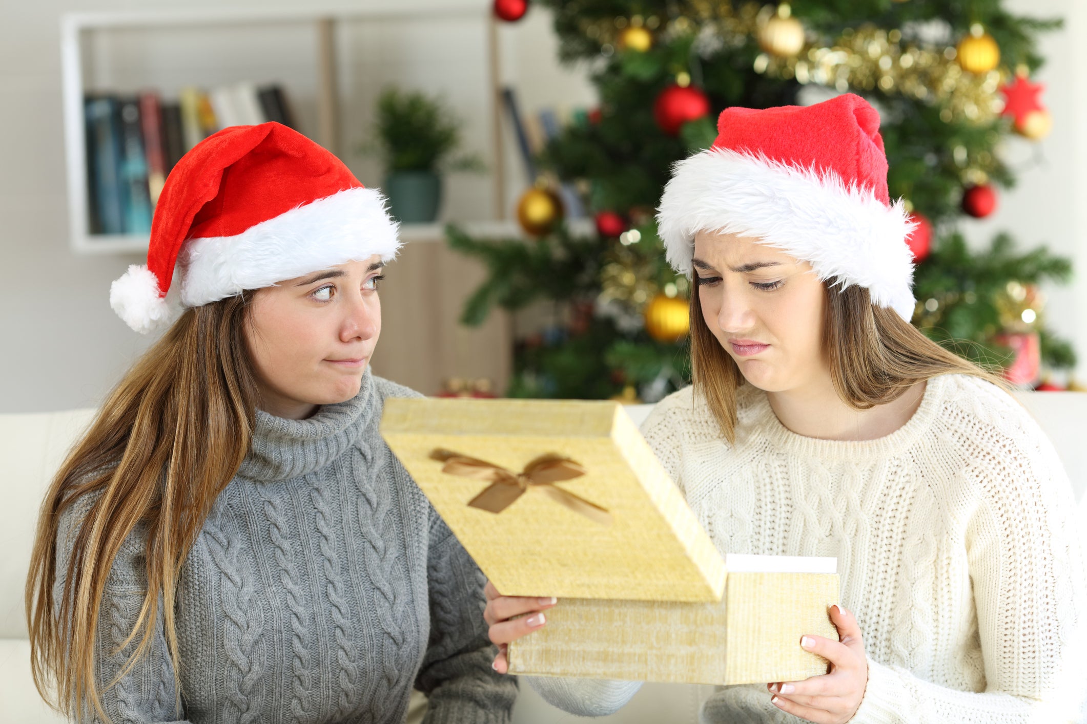 Disappointed woman receiving a gift in christmas