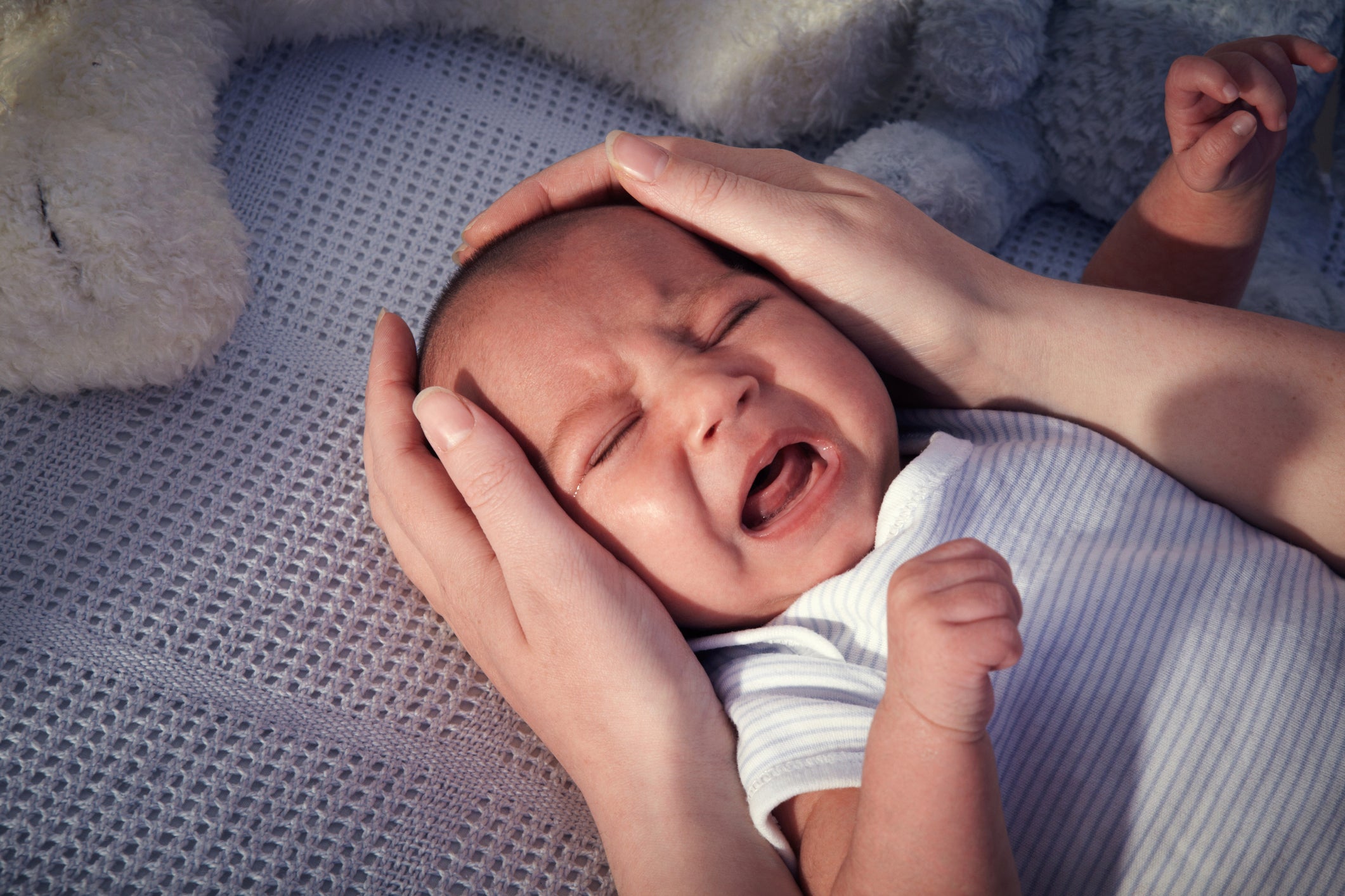 Baby boy in crib crying