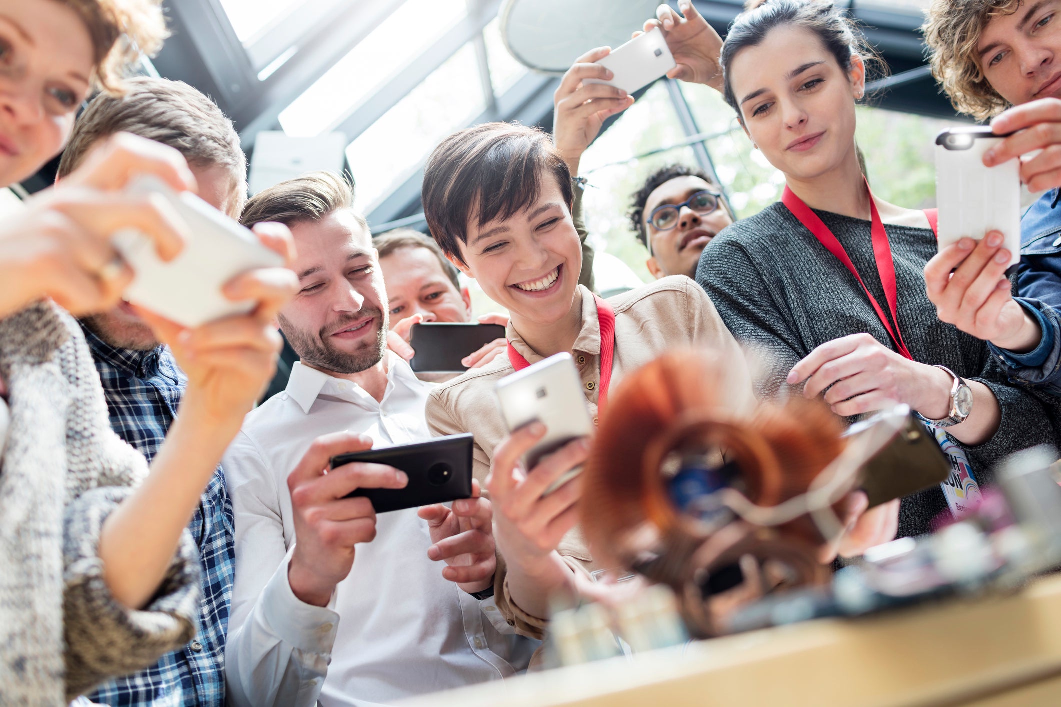 Group with camera phones at technology conference
