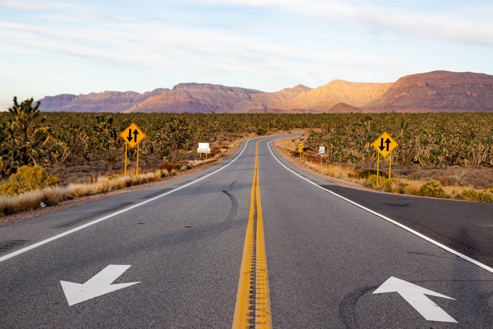 Paved roads with signage from Las Vegas to the Grand Canyon (Photo by Artur Debat/Getty Images).