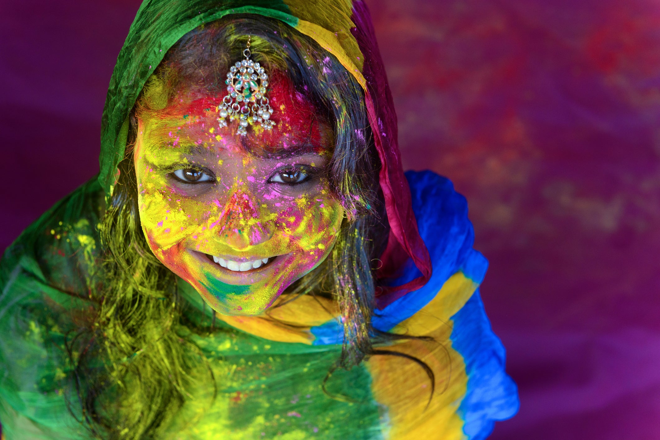 Portrait of a teenage girl enjoying Holi festival.