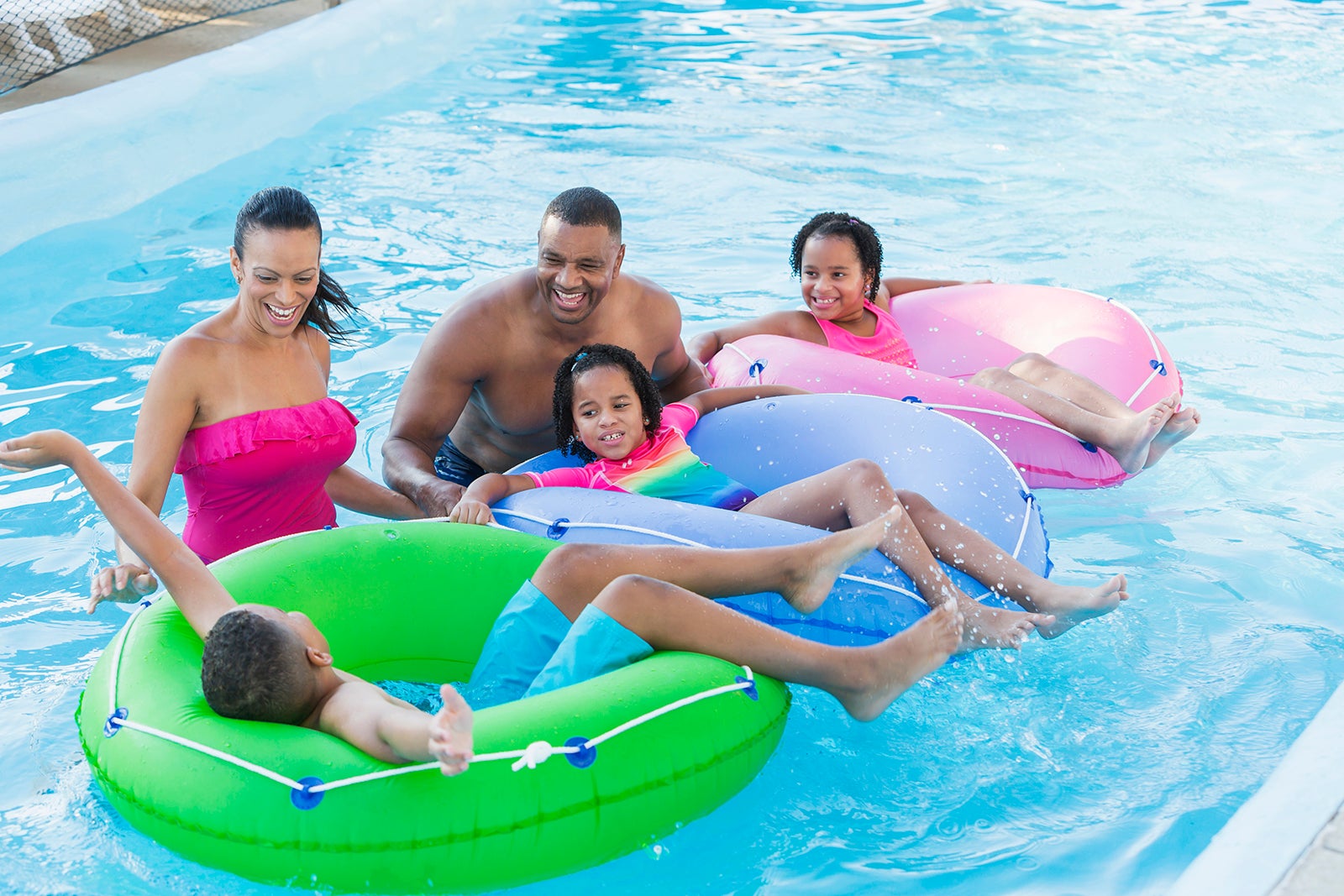 Mixed race family with three children at water park