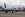 A Boeing Co. 757-232 aircraft, operated by Delta Air Lines Inc., taxis past Southwest Airlines Co. planes parked at a field in Victorville, California, U.S., on Monday, March 23, 2020. Delta Air Lines will park more than 600 planes, or about half its fleet, as it cuts flying capacity 70% amid collapsing travel demand from the coronavirus pandemic. (Photo by Patrick T. Fallon/Bloomberg/Getty Images)