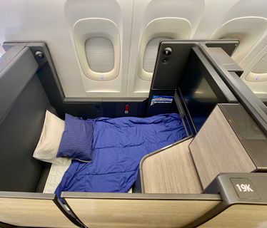 What are the differences between business class and first class? - The  Points Guy