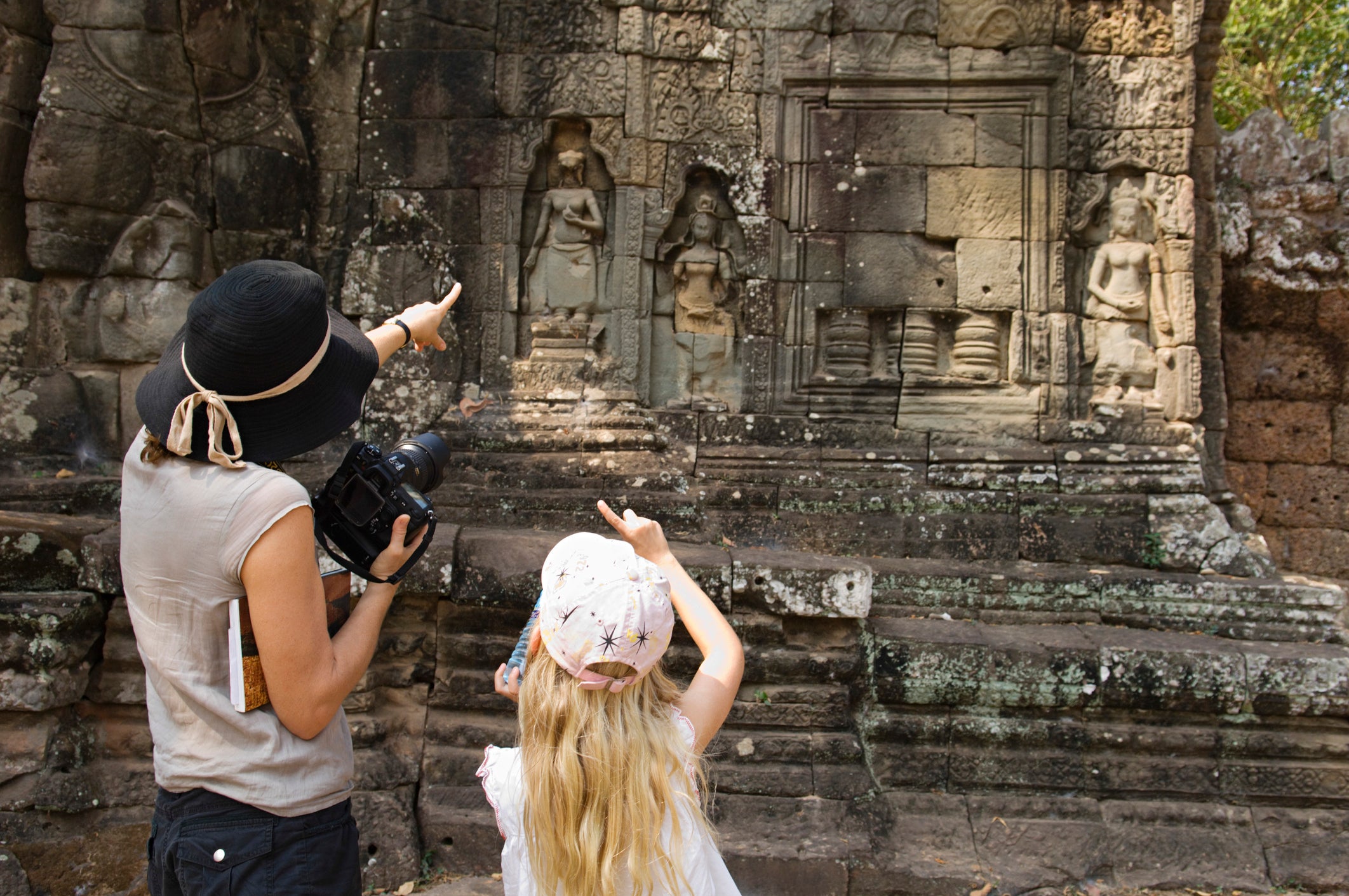 Mother And Daughter Looking At Ancient Temple Cambodia