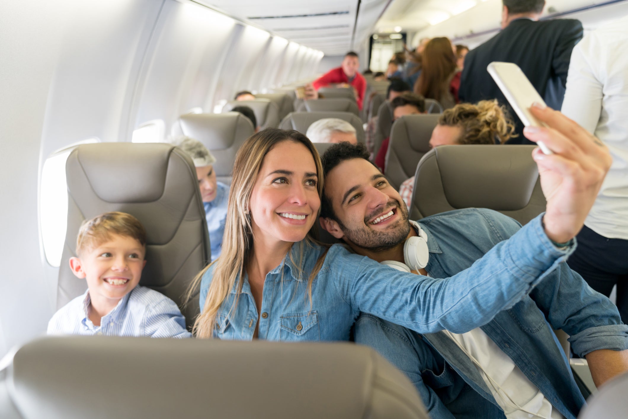 family taking selfie on airplane