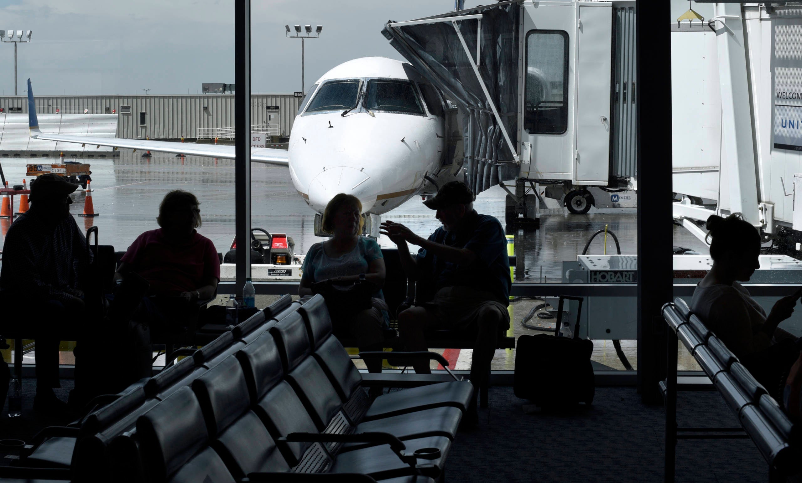 Air passengers waiting for flight at Denver International Airport