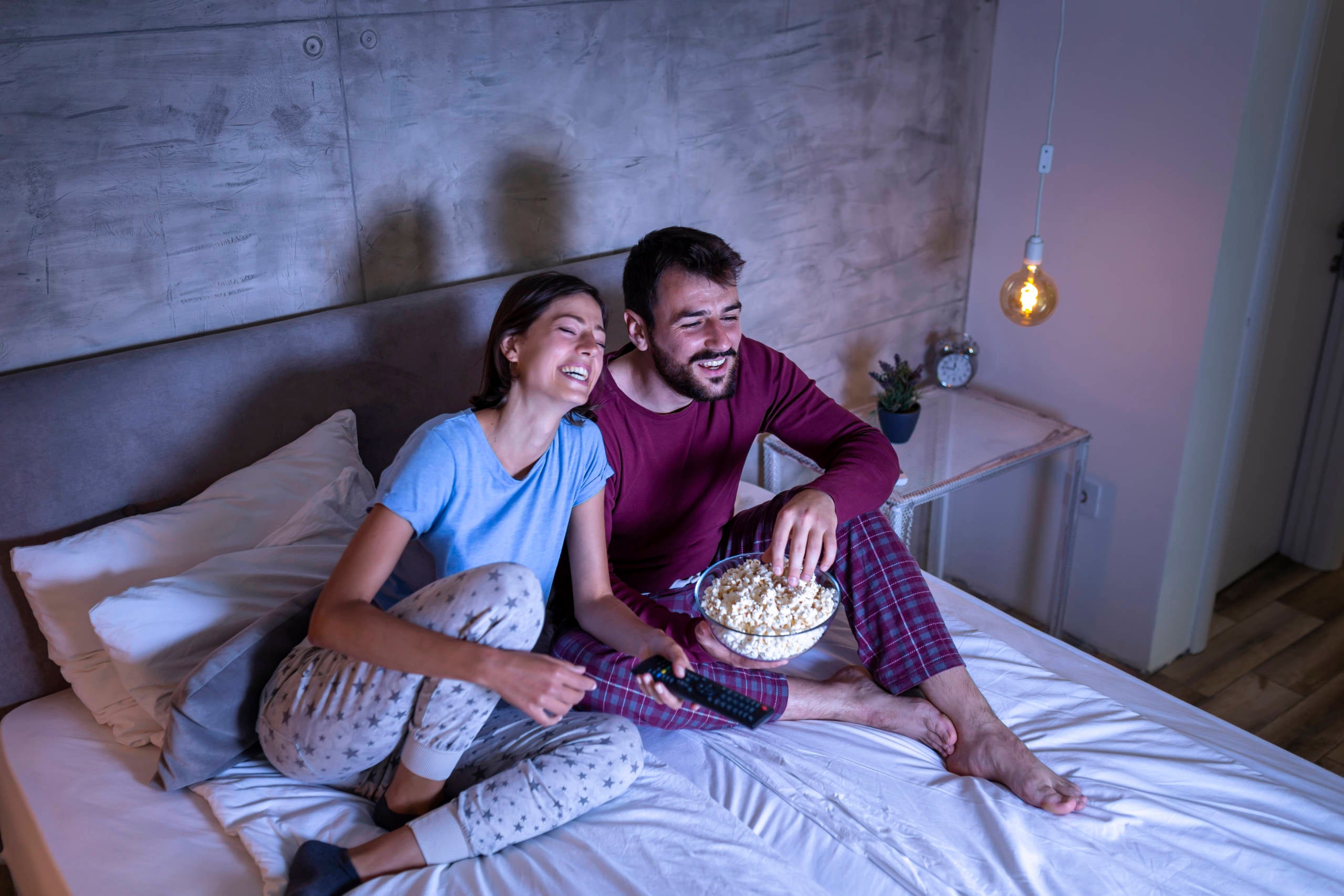 Couple watching a movie in bed