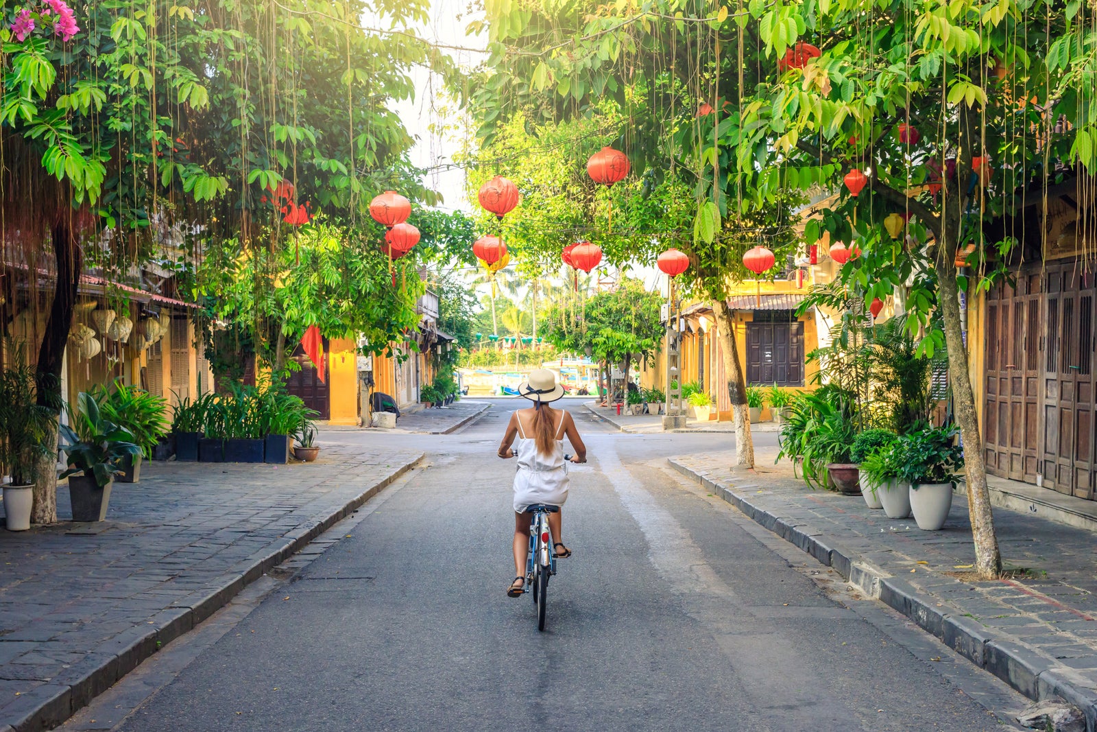 Women visiting the old city of Hoi An in Vietnam by bike during morning