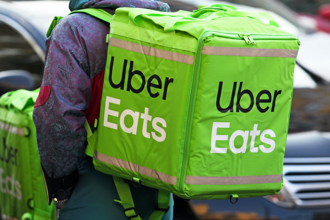 Delivery Cyclist with Green Uber Eats Backpack