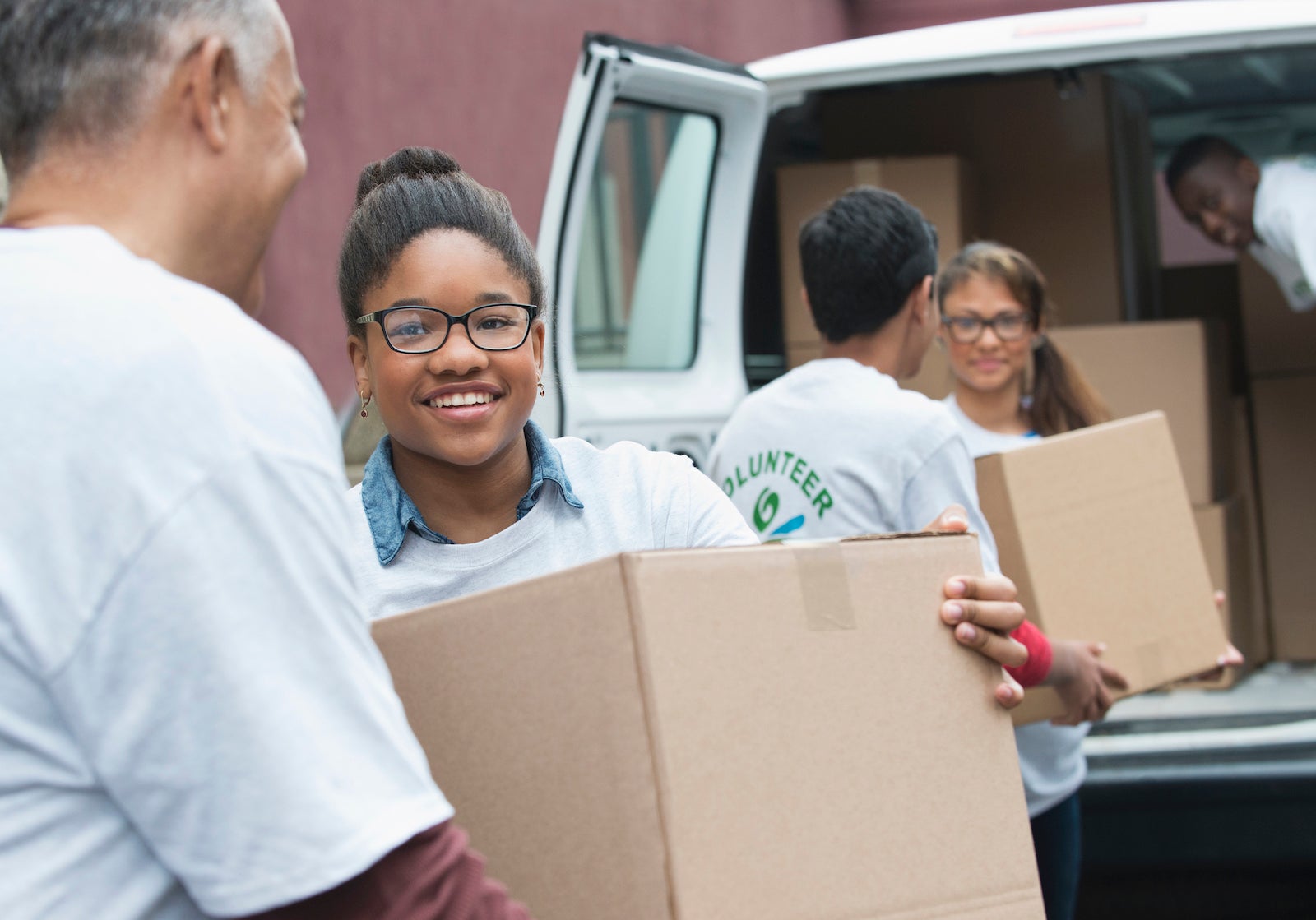 Volunteers loading a van with boxes