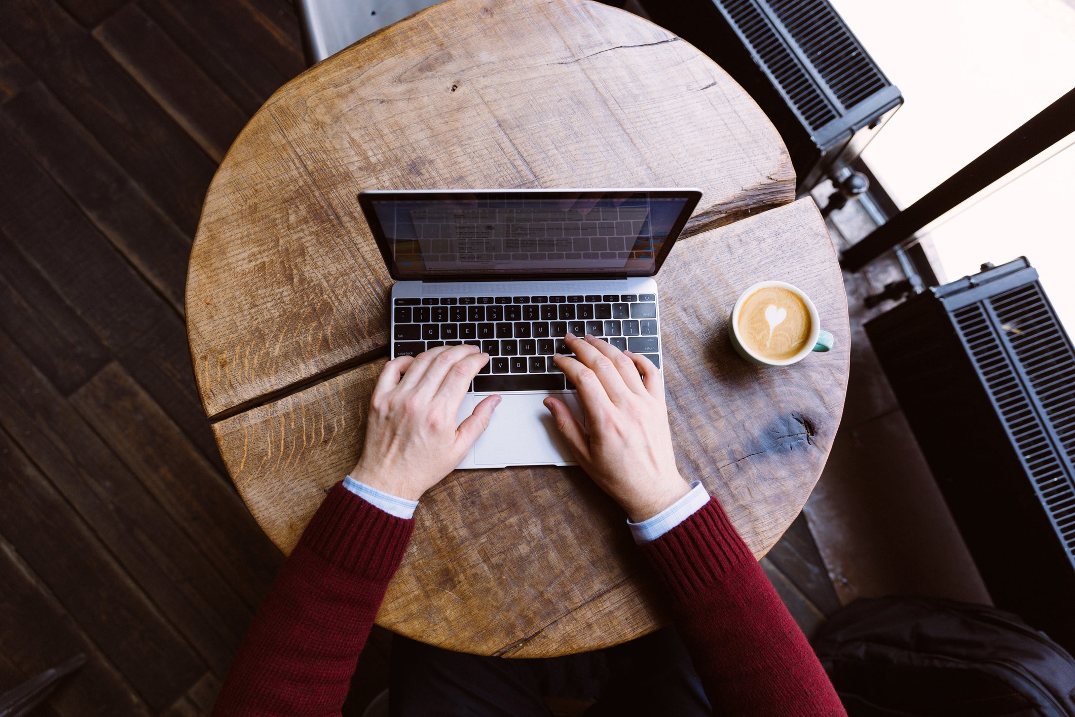 Hands typing on a laptop