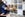 an unknown person holds an urn while standing in front of a blurred-out wall in a columbarium