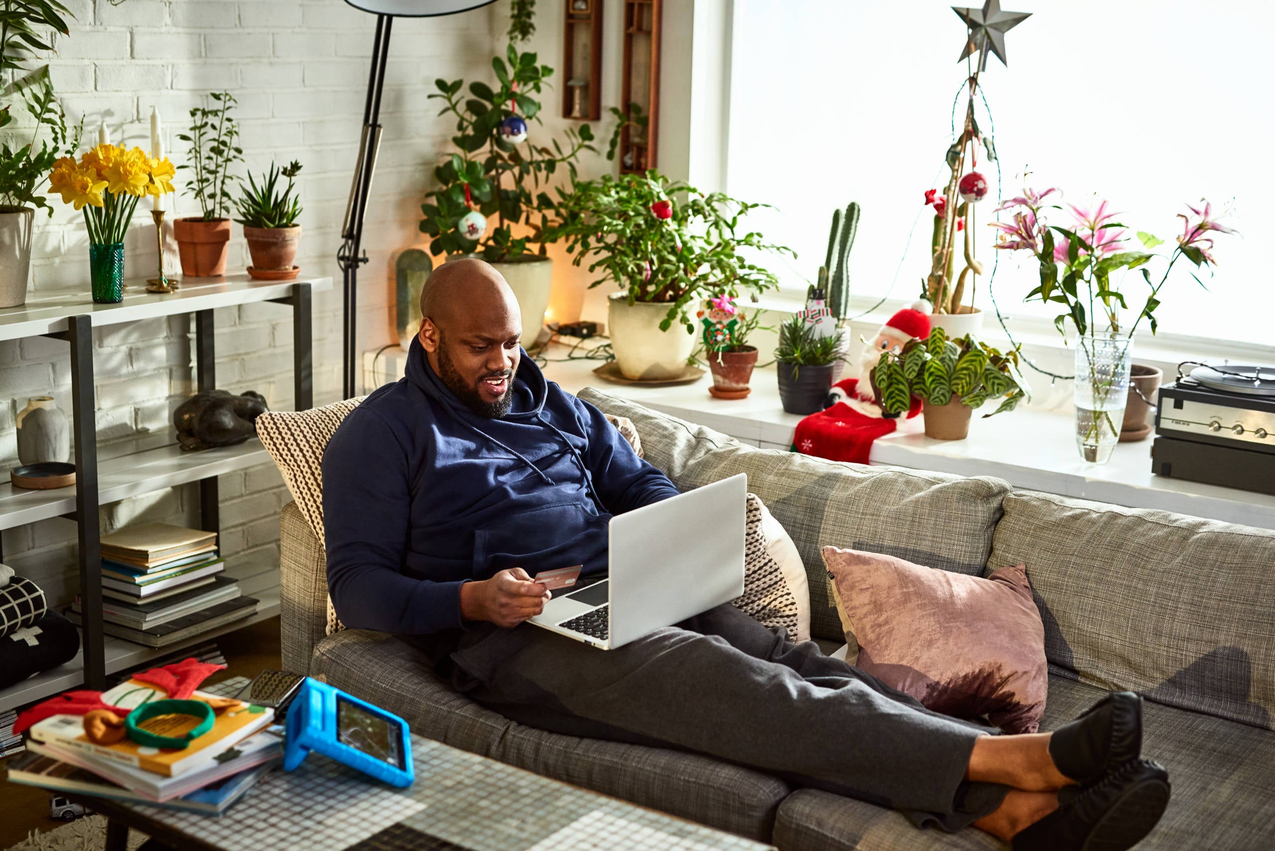Man using computer to buy online at Christmas, comfort, festive season, ecommerce 