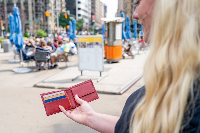Woman holding wallet on street