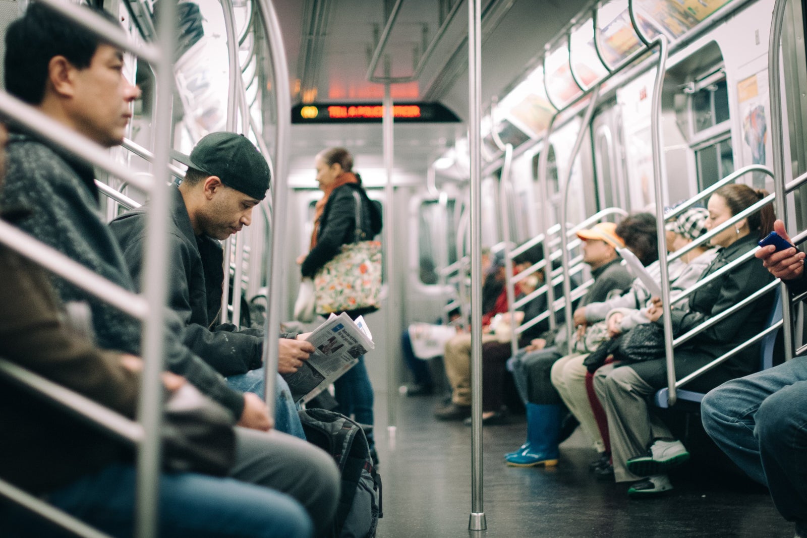 passengers visible inside a New York City subway car