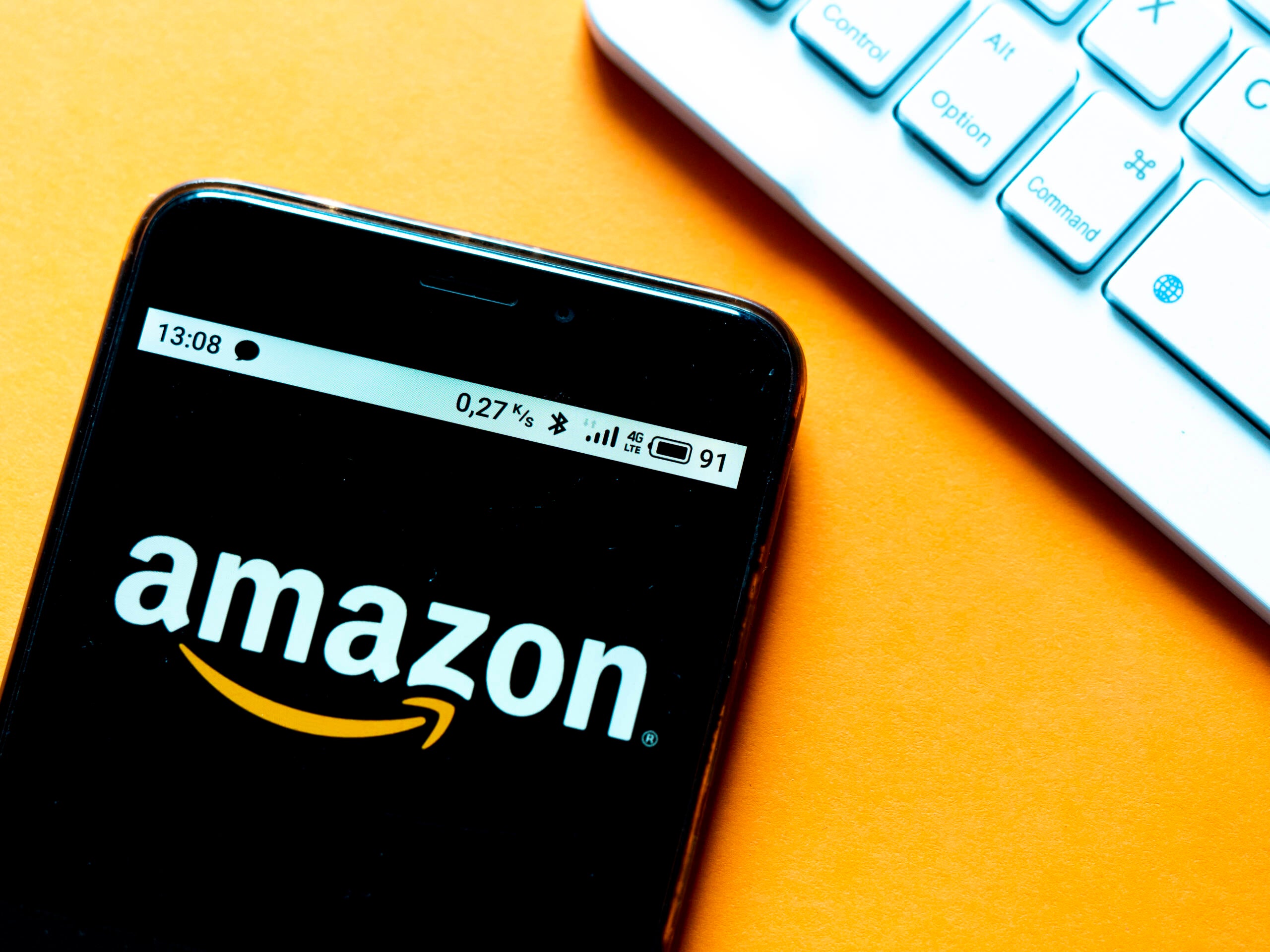 In this photo illustration an Amazon logo is seen displayed