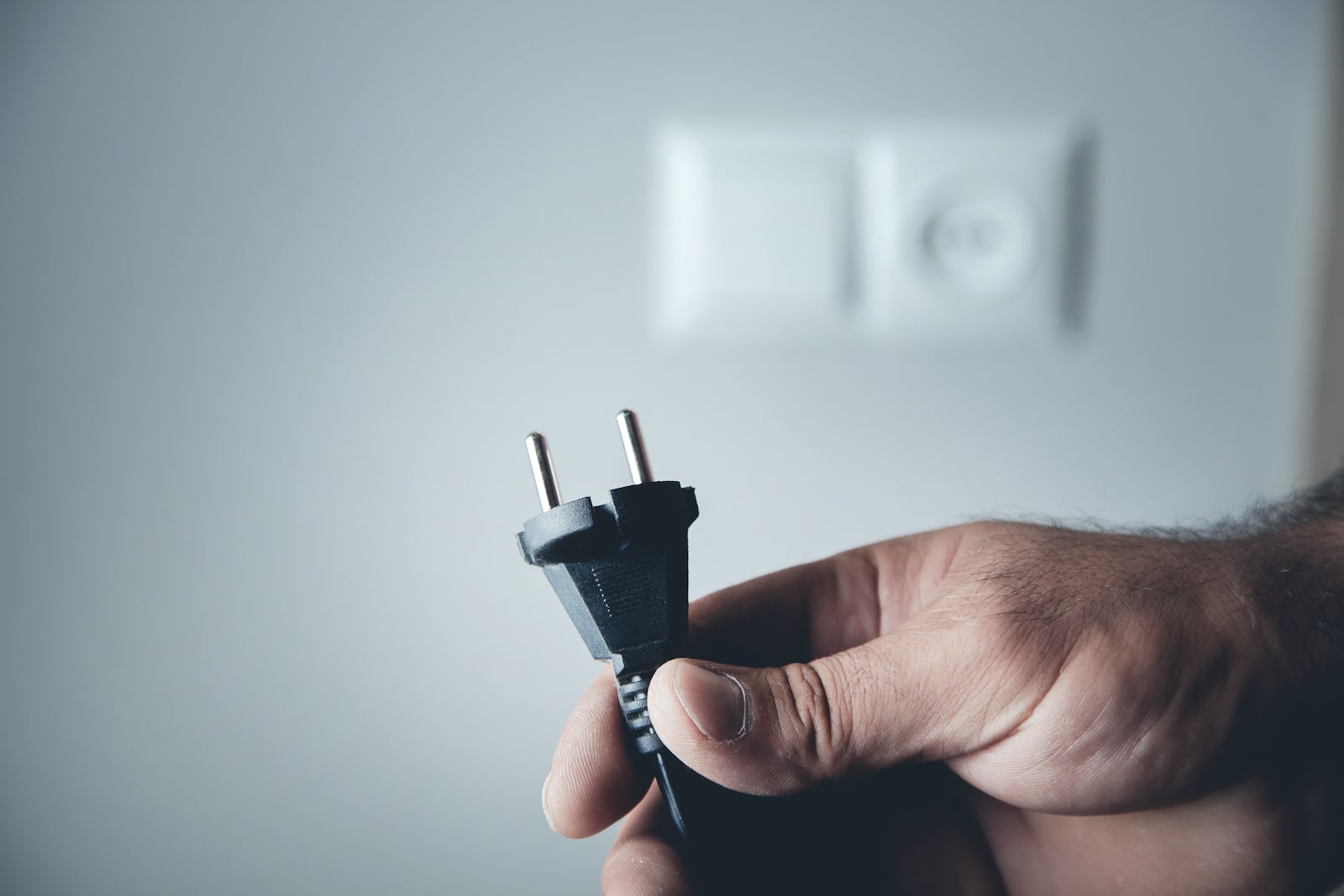 Hand plugging power cord