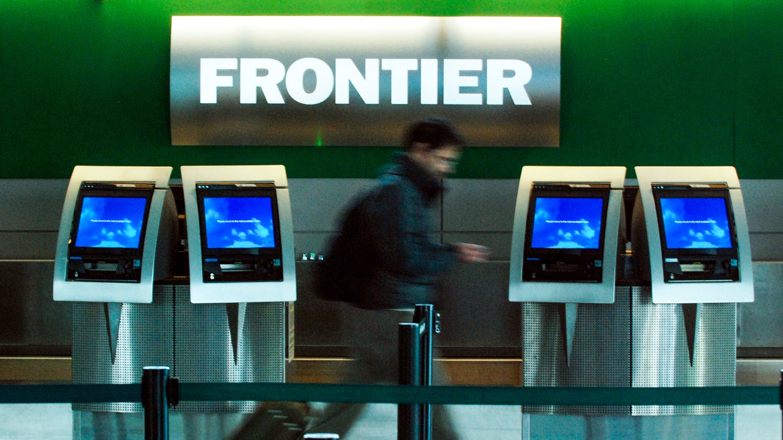 (HC) Frontier-Darius Fatemi, 39, of Denver pass by the ticket counter of Frontier Airlines at DIA on Friday. The Airline filed for Chapter 11 bankruptcy late Thursday in Manhattan. The Denver Post / Hyoung Chang