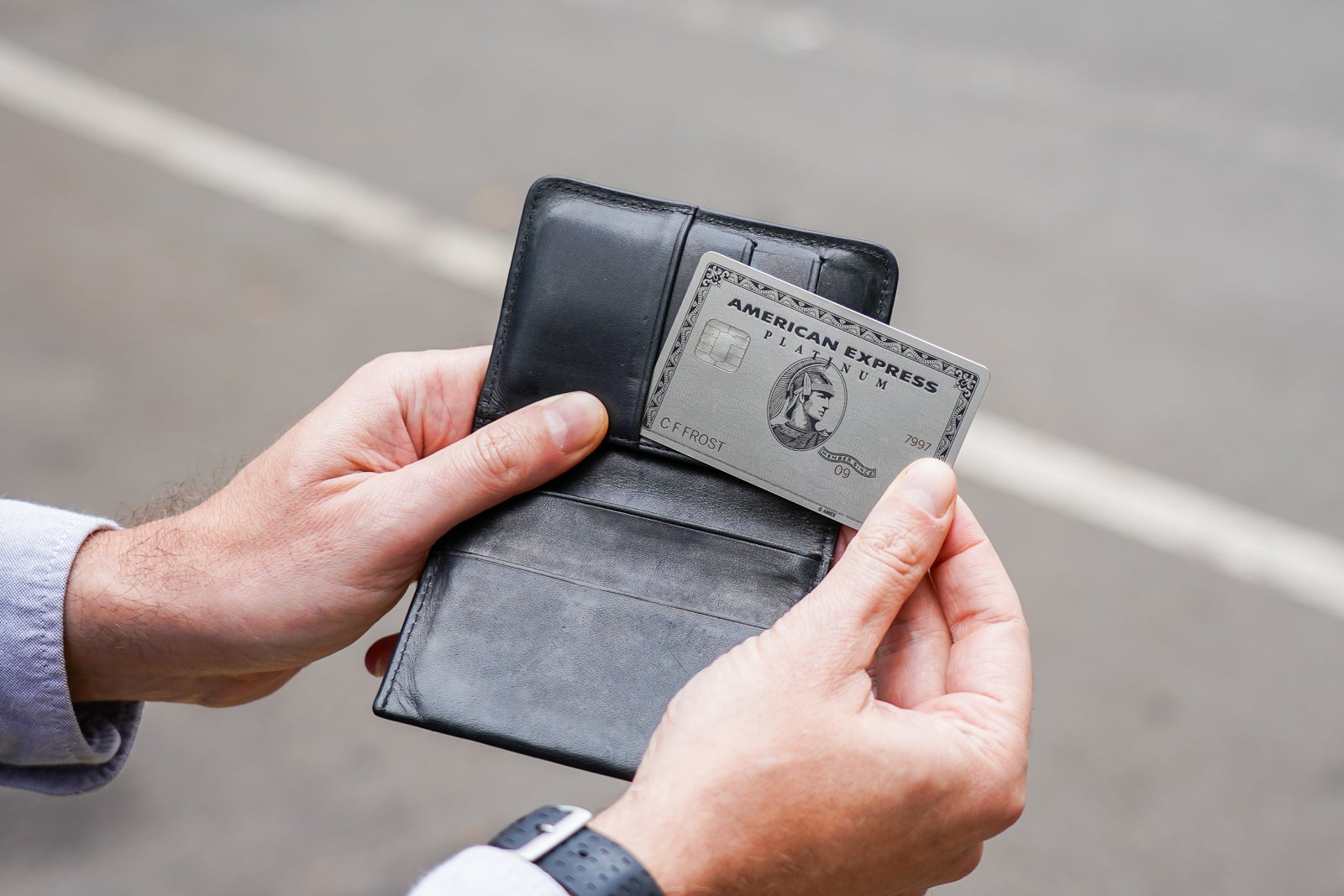 Man pulling Amex card from his wallet