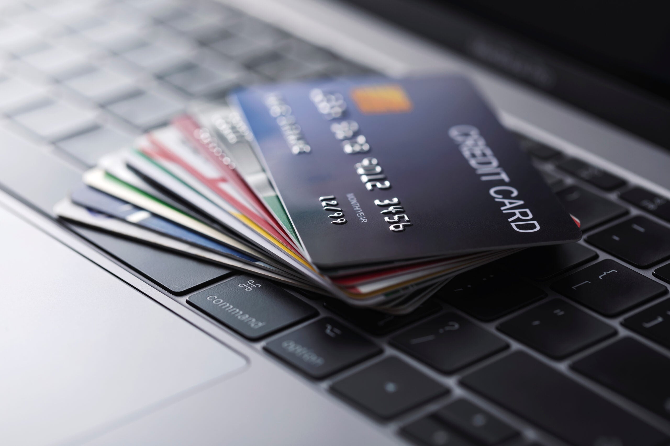 many credit cards sit on a computer keyboard