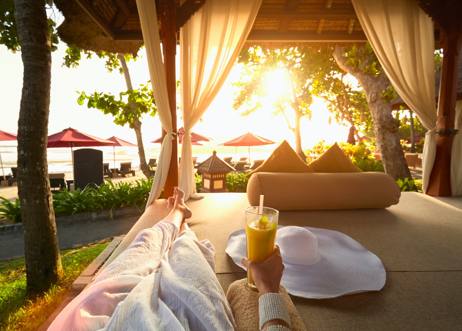 Pacific Islander woman drinking juice in gazebo