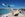 KLM plane flying over St. Maarten beach