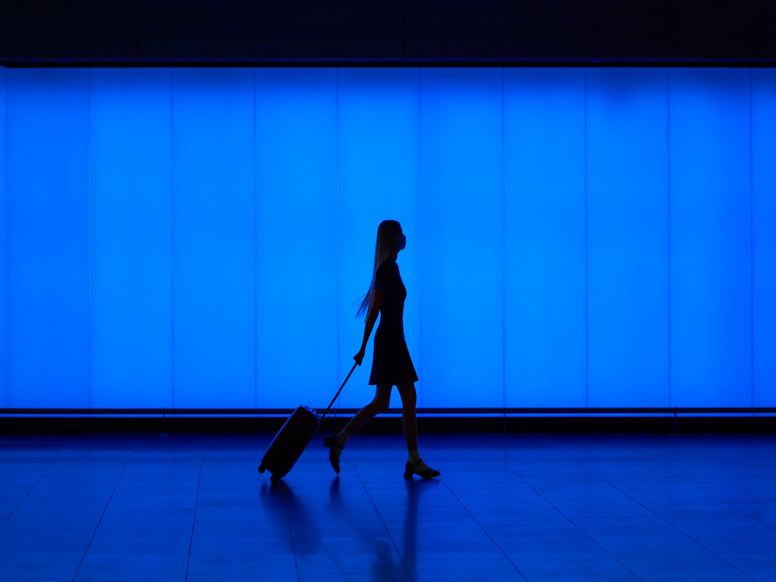 Silhouette of walking young woman