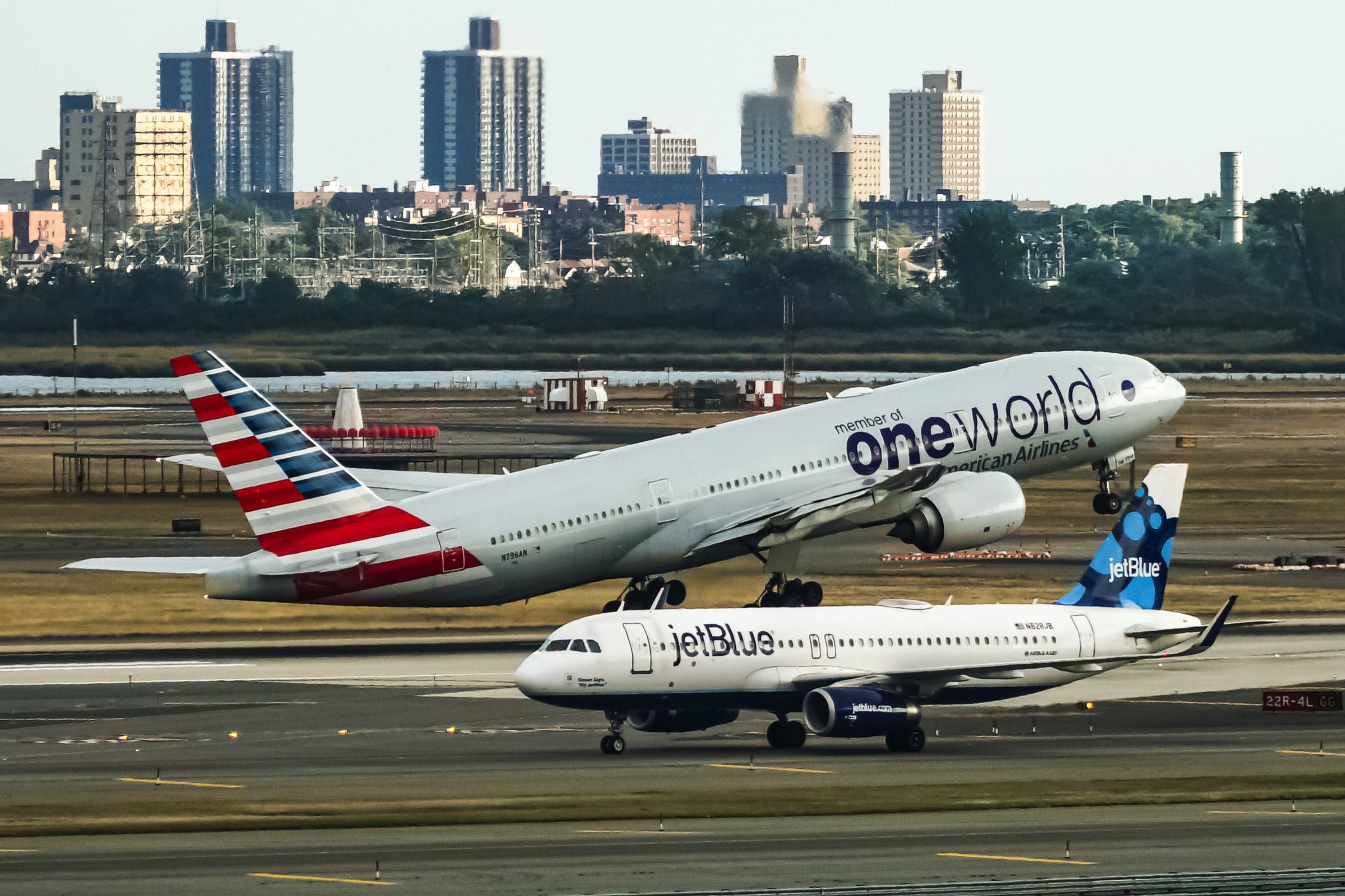 American plane in Oneworld livery and JetBlue plane at JFK airport