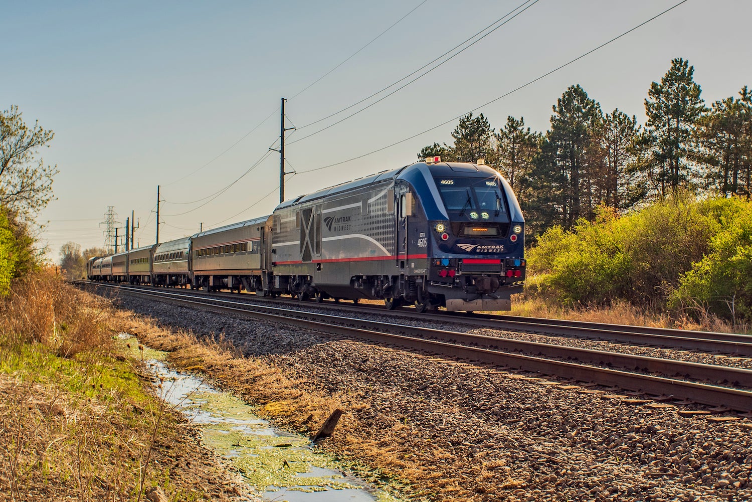 An Amtrak passenger train traveling through rural during Michigan