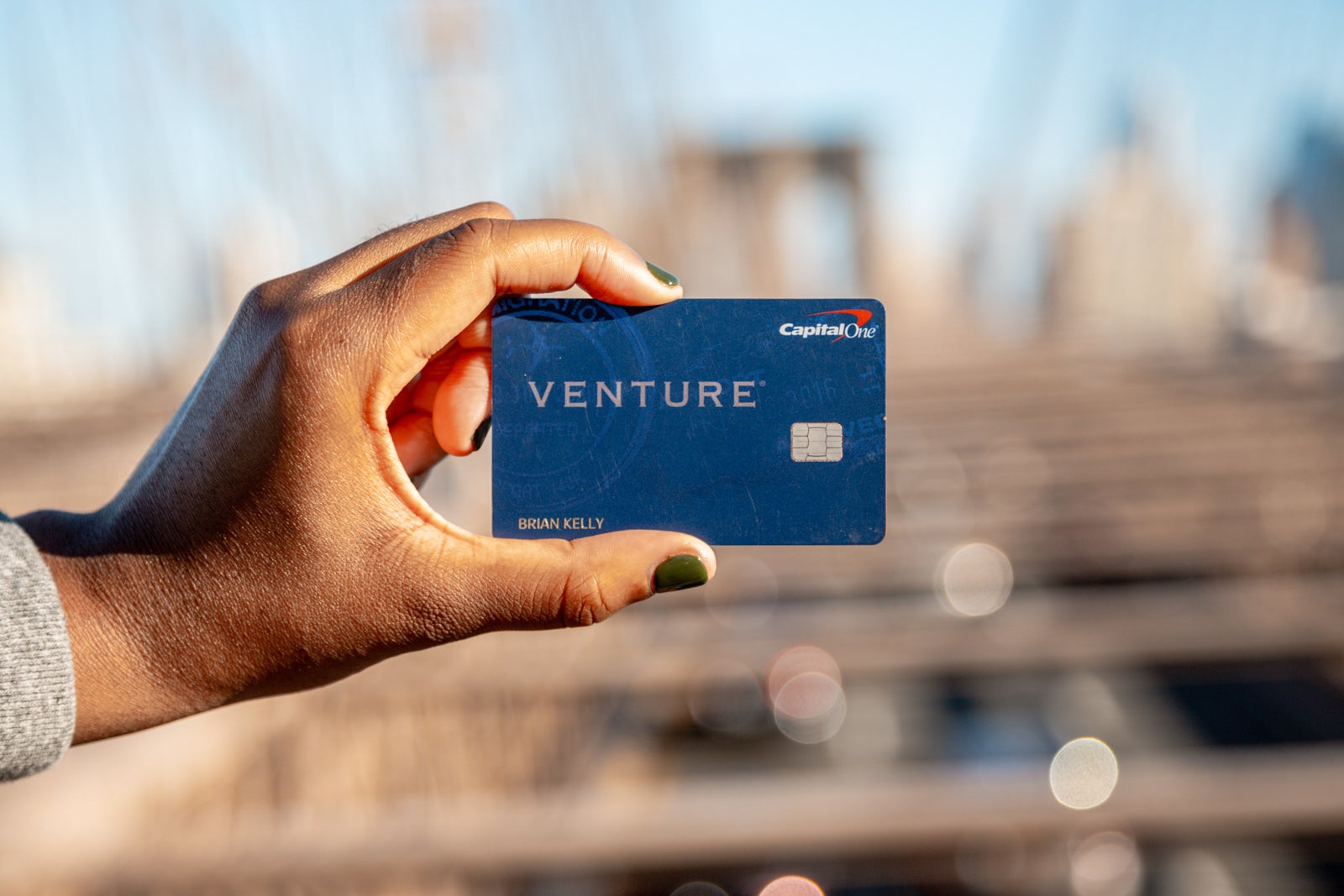 Person holding a Capital One Venture card