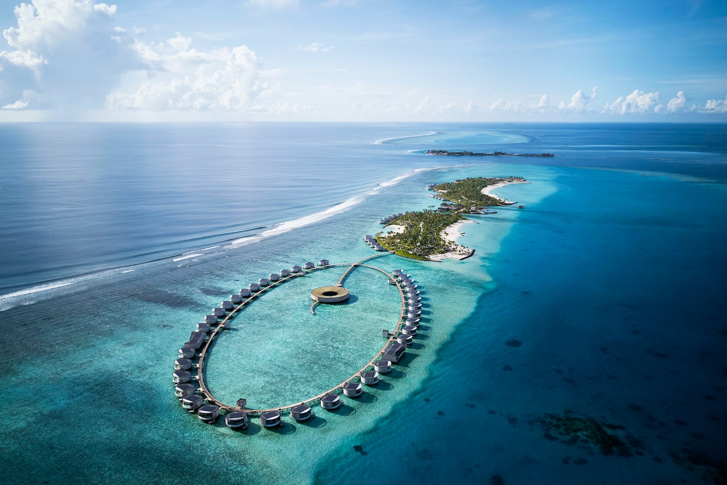 Ritz Carlton Maldives resort aerial view of overwater villas in a lagoon