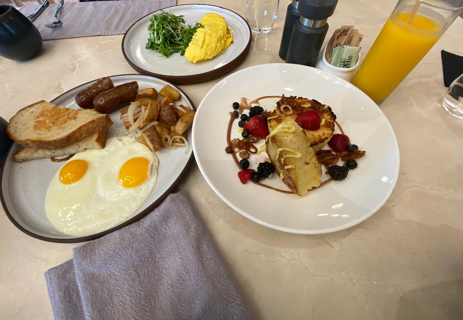 French toast, eggs and sausage and an omelette