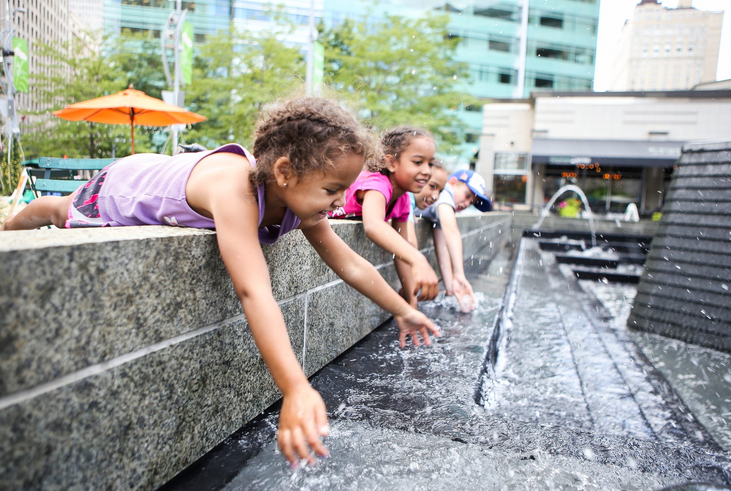 Children,Playing,In,A,City,Fountain.,Shallow,Focus,On,Girl's