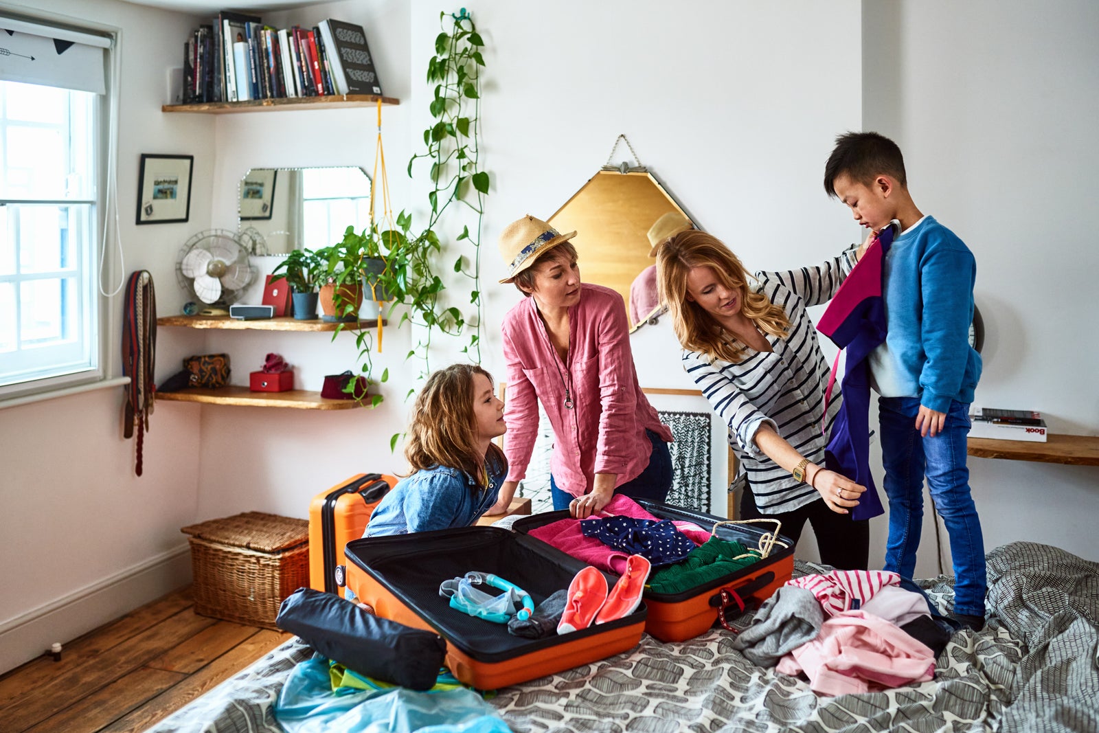 Parents packing suitcases with children