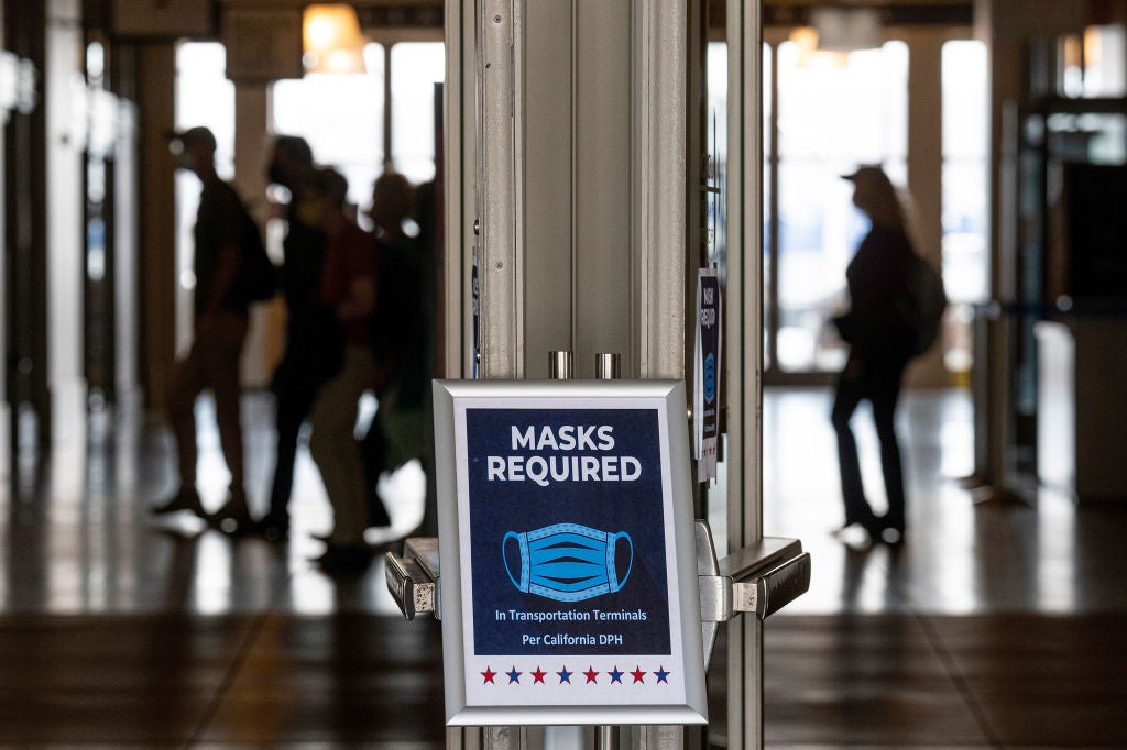 A "Masks Required" sign posted at the entrance to the Ferry Building in San Francisco, California, U.S., on Monday, July 19, 2021. Officials in the San Francisco area are recommending that residents wear masks again indoors in public places regardless of vaccination status. (Photo by David Paul Morris/Bloomberg via Getty Images)
