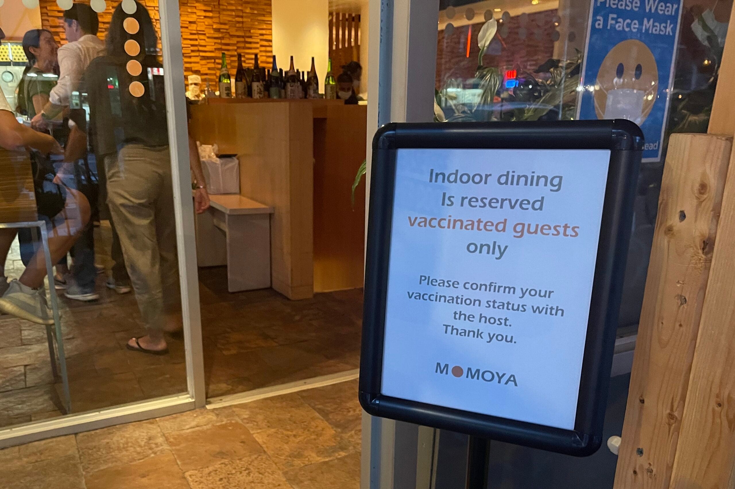 Sign reminding customers that proof of vaccination is required at a restaurant in NYC