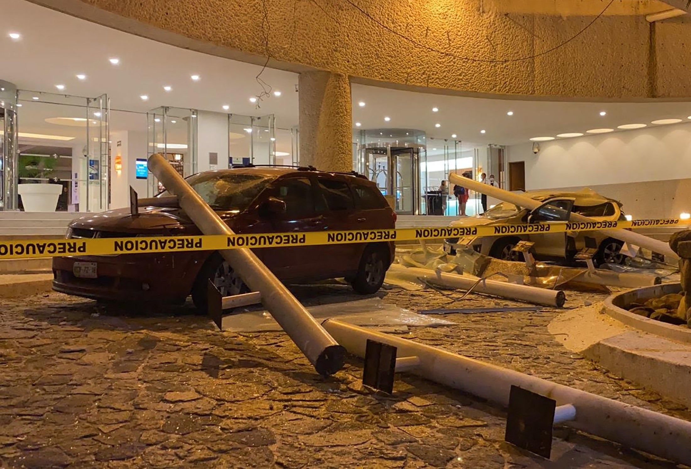 View of damaged cars outside a hotel after a quake in Acapulco, Guerrero state, Mexico on September 7, 2021. - A 6.9 magnitude earthquake struck Mexico on Tuesday near the Pacific coast, the National Seismological Service said, shaking buildings in the capital. The epicenter was 14 kilometers (nine miles) southeast of the beach resort of Acapulco in Guerrero state, the service said. (Photo by FRANCISCO ROBLES / AFP) (Photo by FRANCISCO ROBLES/AFP via Getty Images)