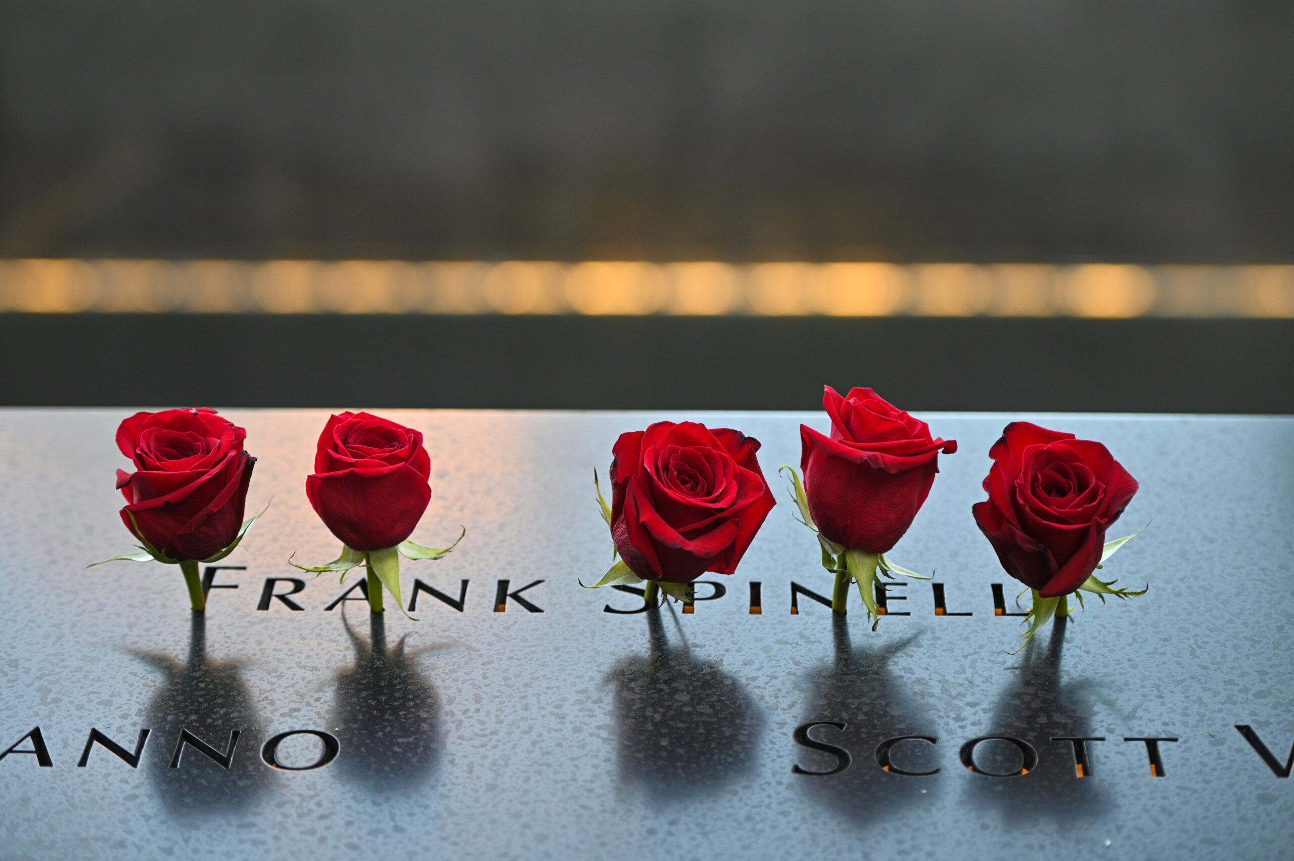 NEW YORK, NEW YORK - SEPTEMBER 11: Roses are placed at the name of Frank Spinelli during a ceremony at the National September 11 Memorial &amp; Museum commemorating the 20th anniversary of the September 11th terrorist attacks on the World Trade Center on September 11, 2021 in New York City. The nation is marking the 20th anniversary of the terror attacks of September 11, 2001, when the terrorist group al-Qaeda flew hijacked airplanes into the World Trade Center, Shanksville, PA and the Pentagon, killing nearly 3,000 people. (Photo by Anthony Behar - Pool/Getty Images)