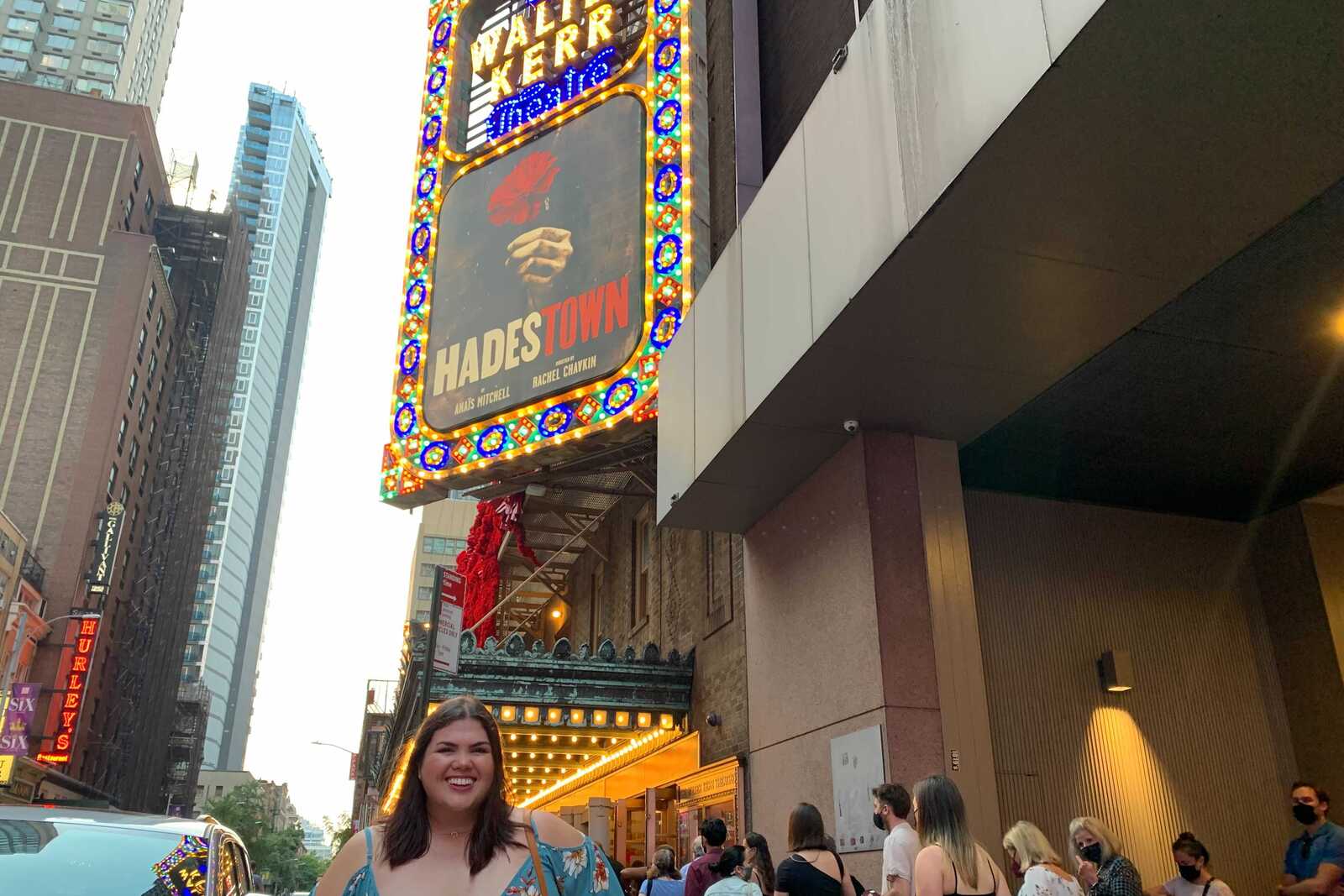 Madison smiles below the Hadestown marquee