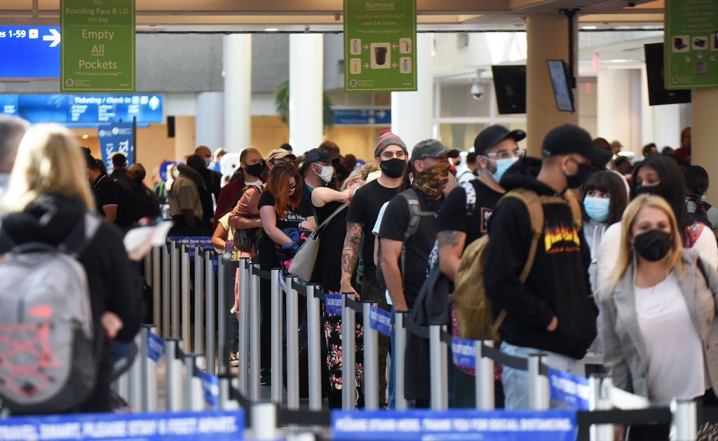Orlando, Florida, United States - People wait in line at a TSA security checkpoint at Orlando International Airport on Thanksgiving eve, November 25, 2020, in Orlando, Florida. Thousands of travelers are ignoring CDC warnings to avoid holiday travel as COVID-19 cases are surging across the United States
