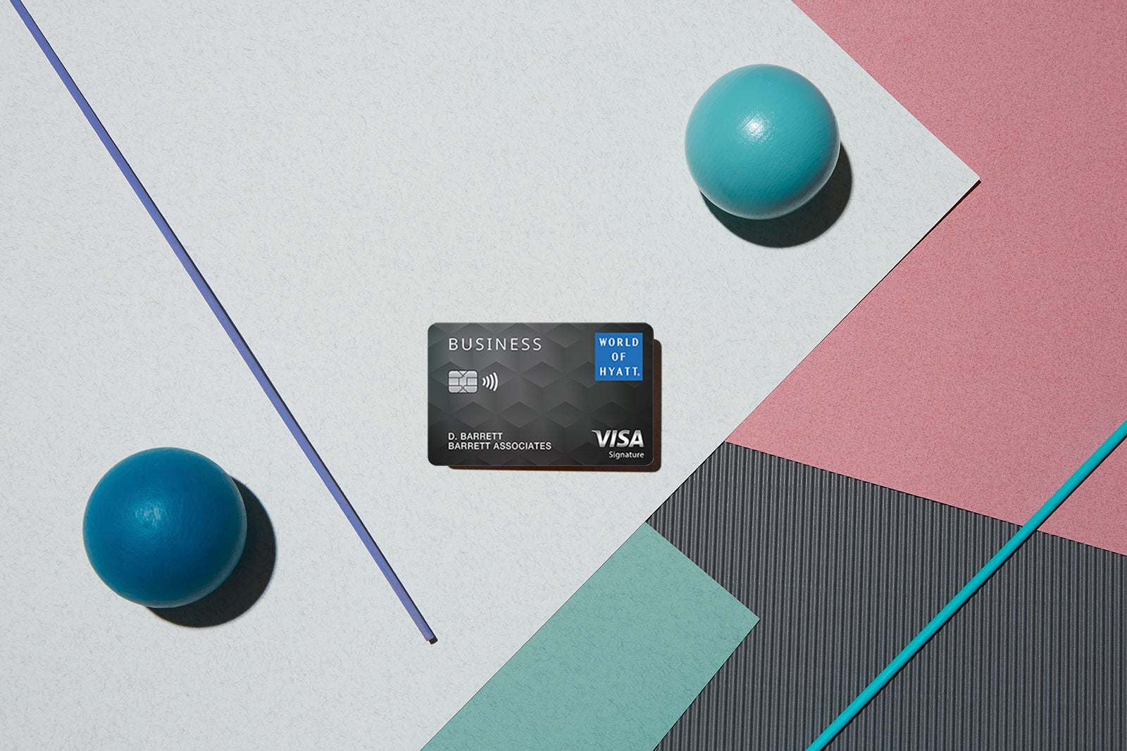 photo shows the World of Hyatt Business Credit card set against a multi-colored background