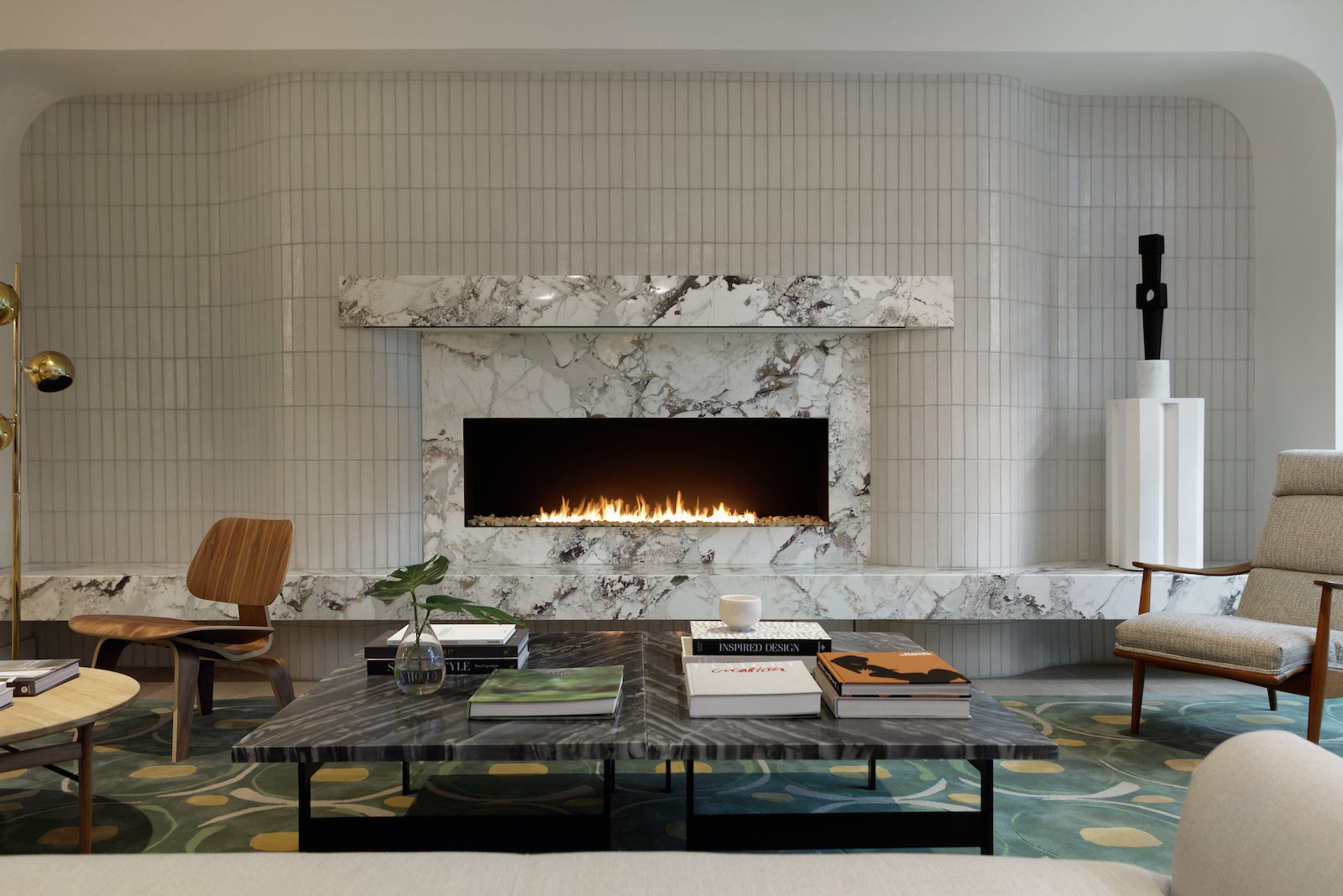 marble fireplace in hotel lobby surrounded by chairs