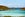 aerial view of turquoise waters and beach resort in front of distant mountains