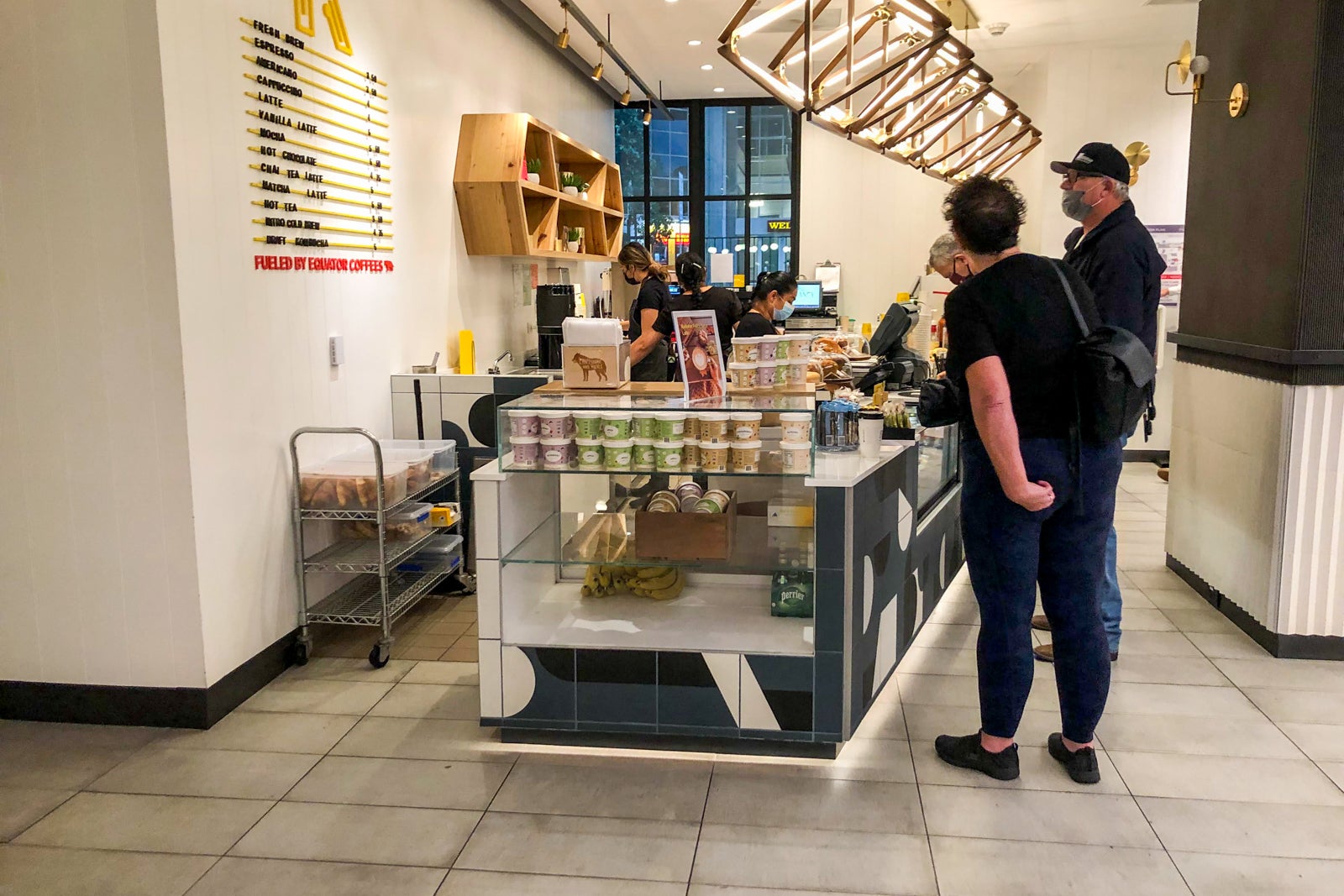 Hotel guests getting a cup of coffee or pastry at the hotel's cafe