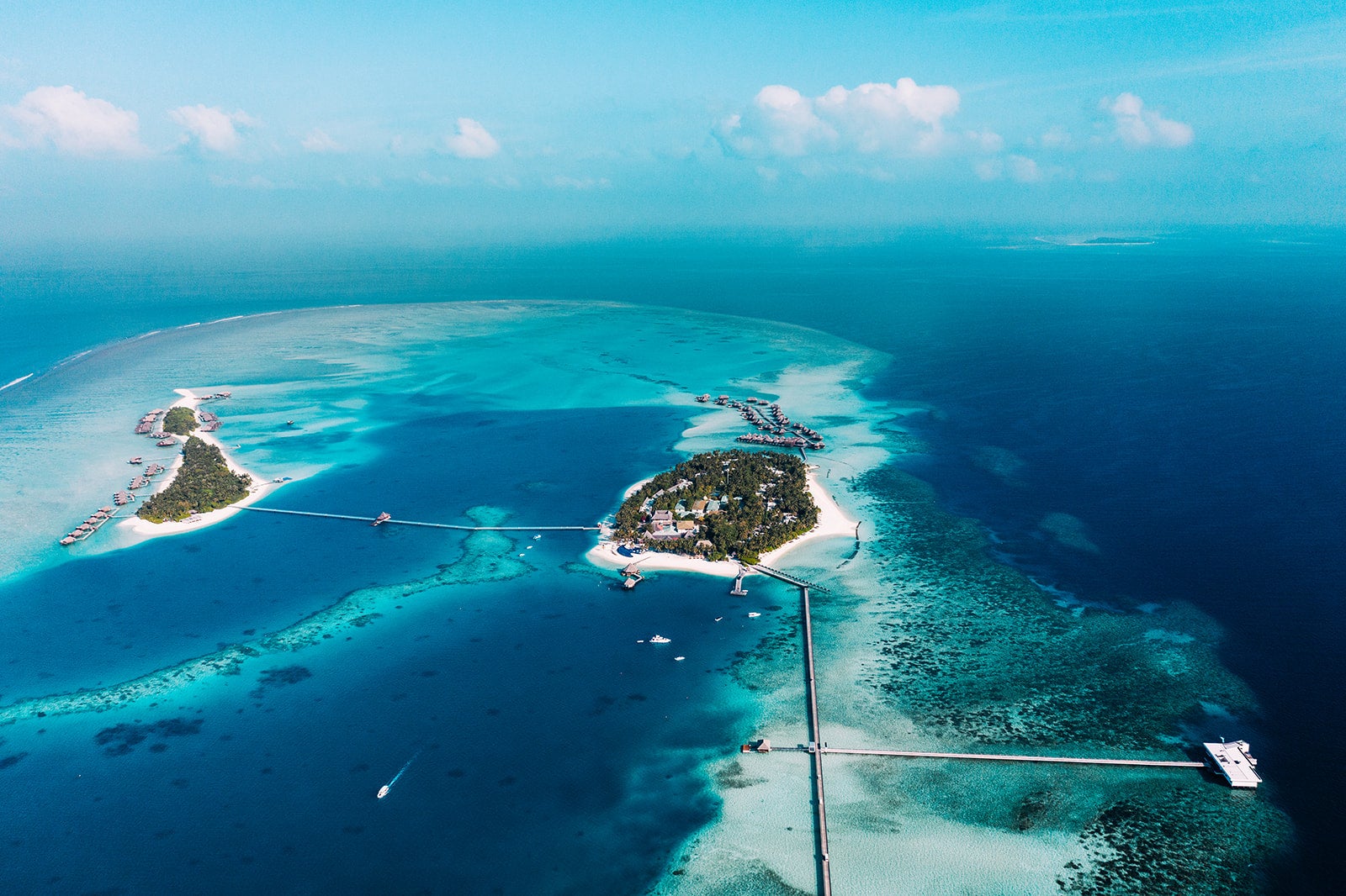 aerial photo fo two islands in crystal-clear water