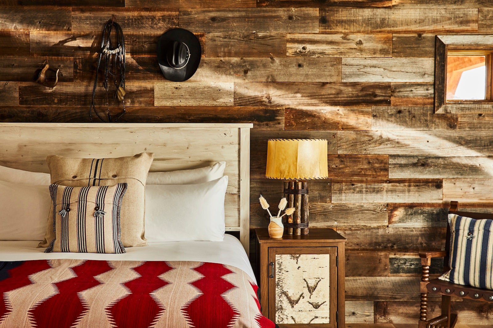 wooden wall with rustic decor, bed and chair