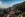 mountainside resort with red roof and tall, green trees