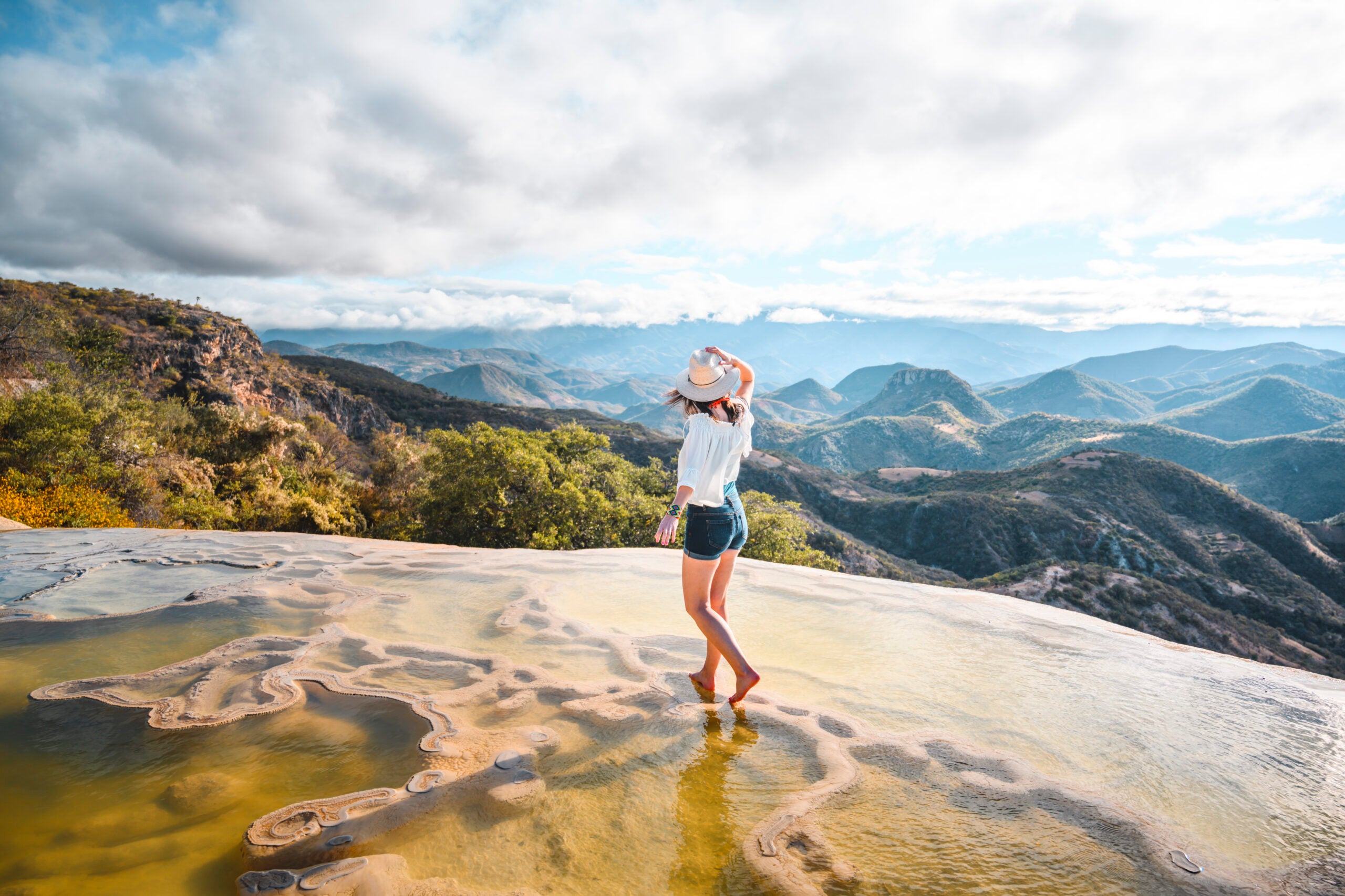 Woman walking on the limestone rock formations at Hierve el Agua, Oaxaca, Mexico