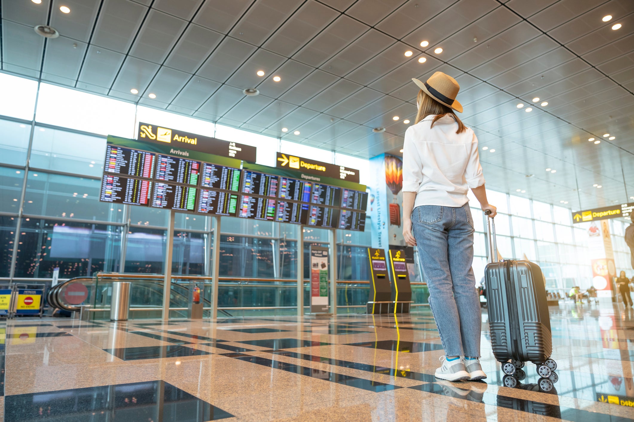 Rear tourist woman at international airport